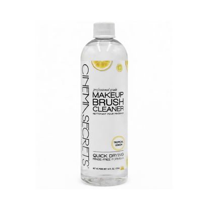 Cinema Secrets makeup brush cleaner products with lemons on a reflective surface.