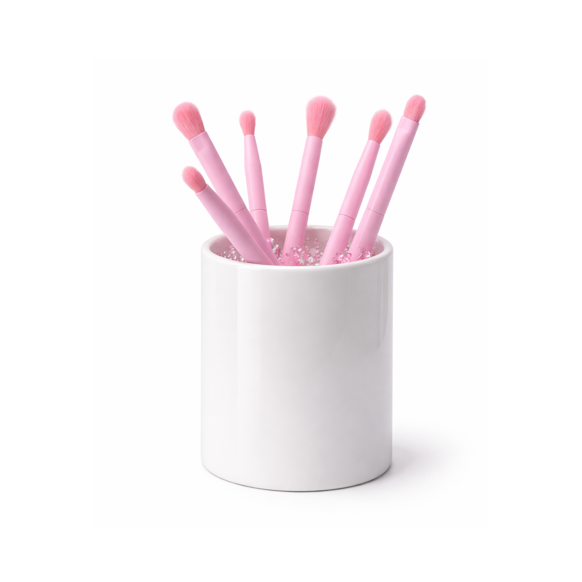 Tubo de acrílico cristalino que permite ver el tono brillante y traslúcido de las brochas para ojos en su interior.